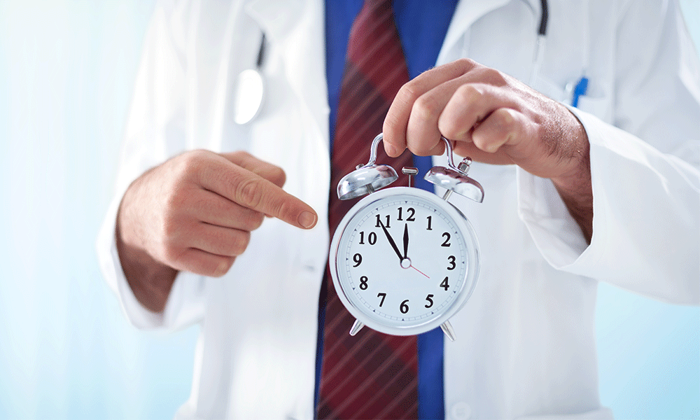 doctor pointing at clock