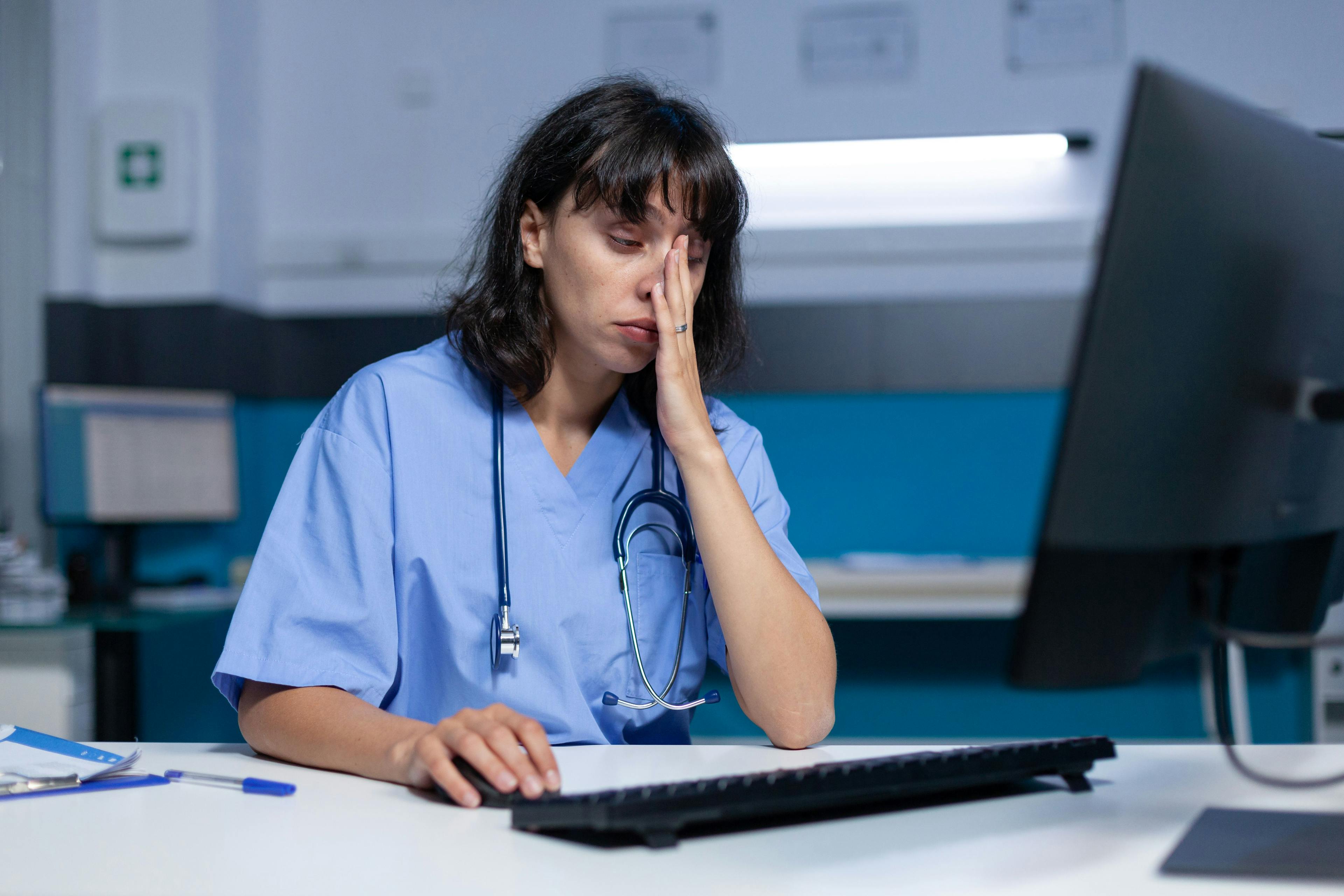 Doctor rubs face in front of computer | © DC Studio - stock.adobe.com